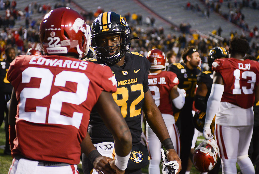 Daniel Parker Jr. shakes the hand of Arkansas linebacker Deon Edwards